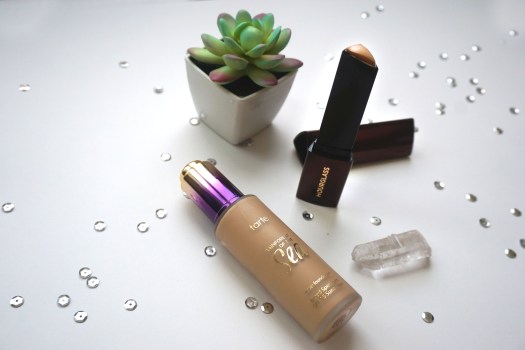 glass bottle and foundation stick with succulent and quartz