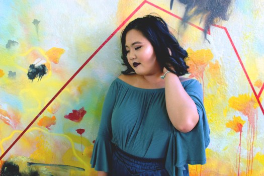 megan in front of mural