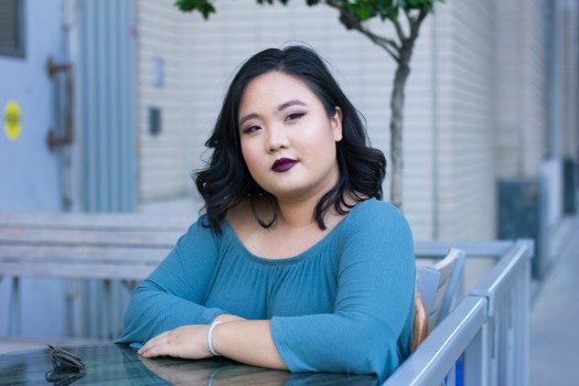 megan sitting at table looking away
